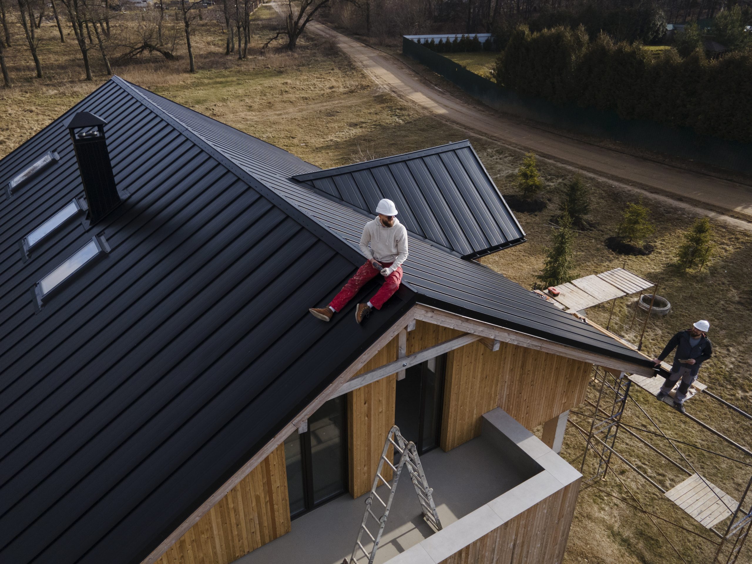 long-shot-man-with-helmet-sitting-roof